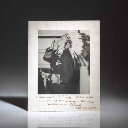 Inscribed photograph of Admiral Chester W. Nimitz at the Mayflower Hotel, being made an honorary Chief by the Ottawa Indian Foundation of Michigan. He was given the honorary name of "Be-lea-nage," meaning "The Winner."