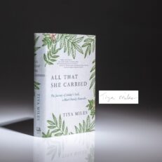 First edition of All That She Carried by Tiya Miles, signed by the author on a bookplate.