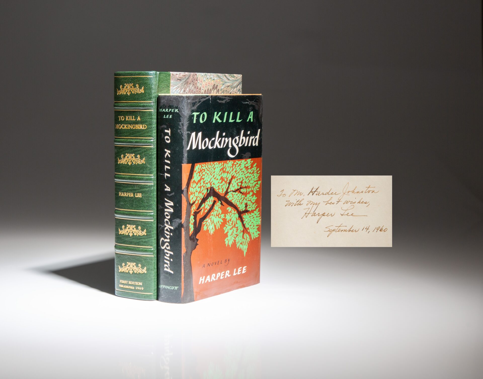 First edition, first printing of To Kill A Mockingbird by Harper Lee, with a tipped-in signature from September 1960. In the publisher's first issue dust jacket.