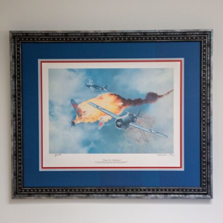 The limited edition of "Victory Over Guadalcanal" by Ted Wilbur, from a limited edition of 750 prints, individually numbered and signed by the artist. Additional signature of General Joseph J. Foss on the matte.