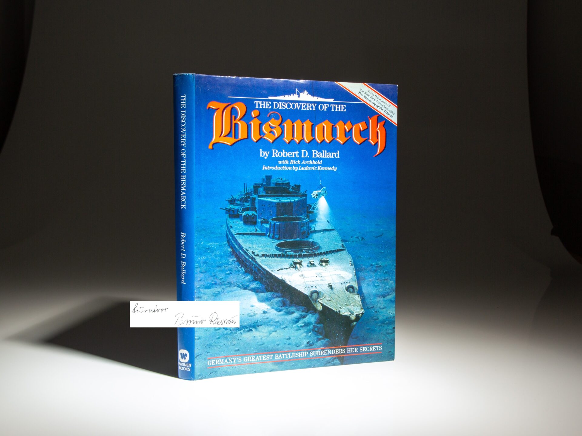 The first edition of The Discovery of the Bismarck by Robert D. Ballard, signed by Bismarck survivor Bruno Rzonca.