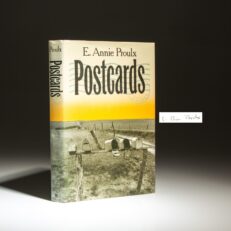 The signed first edition, first printing of Postcards by Edna Ann Proulx, winner of the Faulkner Award.