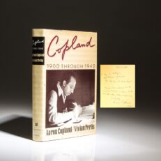 Signed first edition of Copland: 1900 Through 1942 by Aaron Copland and Vivian Perils, with an inscription by the author.
