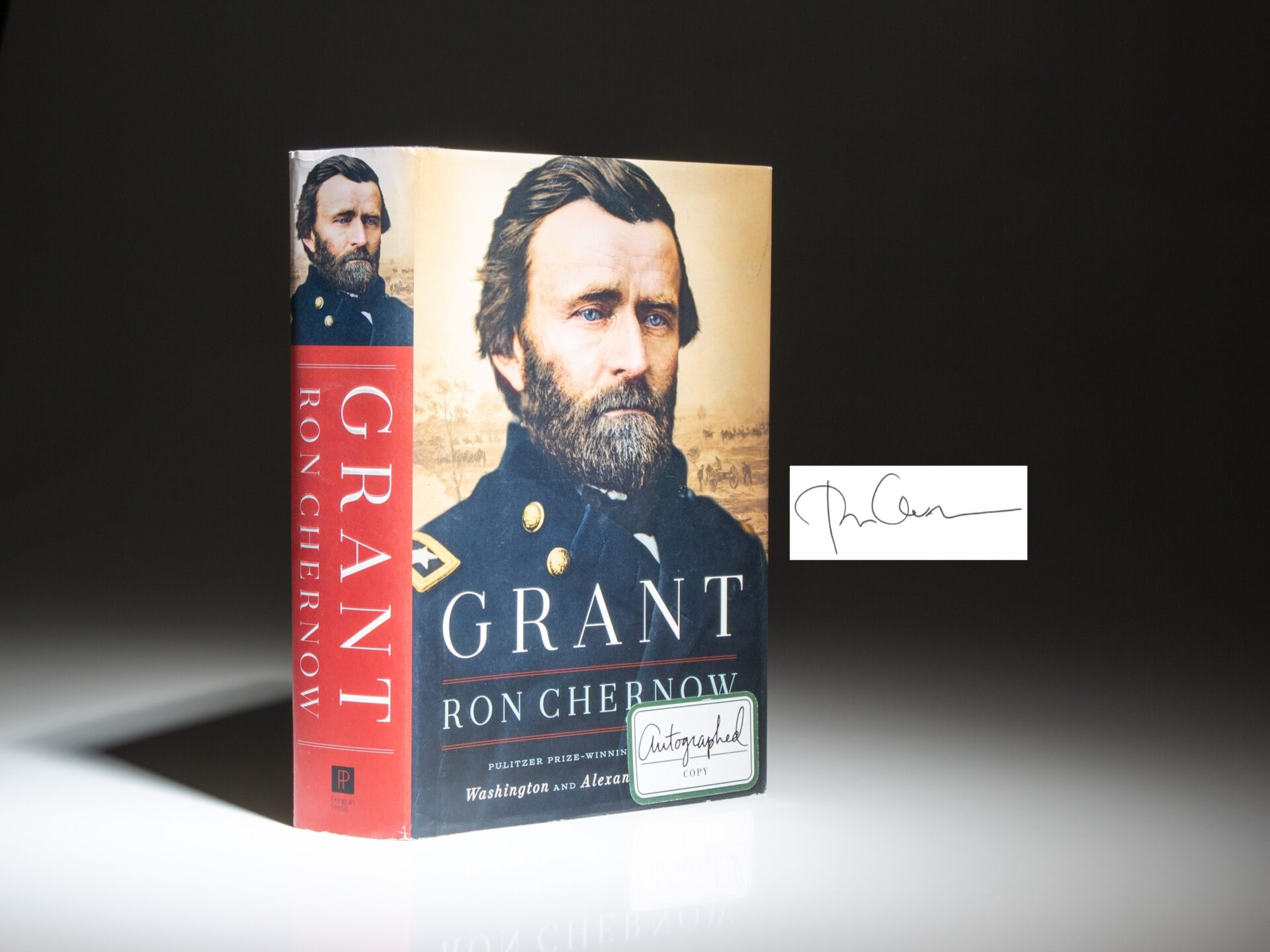 The first edition, first printing of Grant by Ron Chernow, signed on a Penguin Press bookplate.