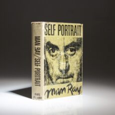 The first edition, first printing of Self Portrait by Man Ray, with a Paris post card from Charles Whaley laid-in.