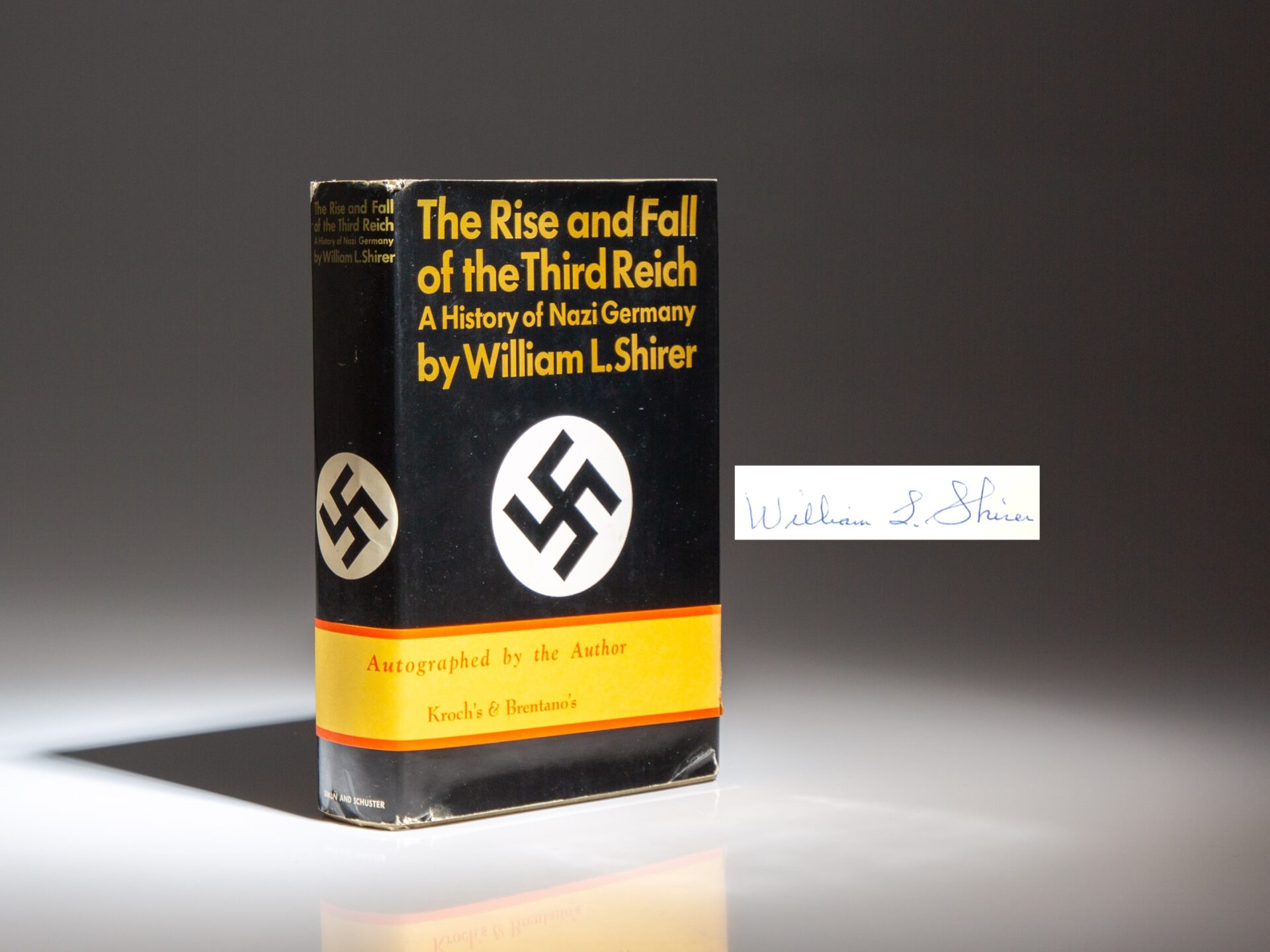 The first edition of The Rise and Fall of the Third Reich, signed by William L. Shirer, with the belly band from Kroch & Brentano's.