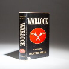 The first edition, first printing of Warlock by Oakley Hall, with the publisher's dust jacket.
