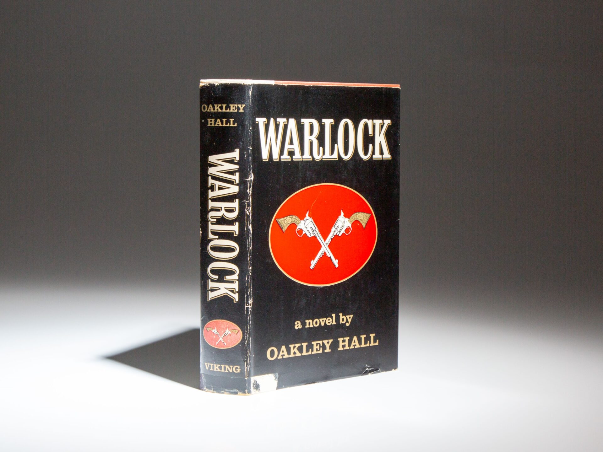 The first edition, first printing of Warlock by Oakley Hall, with the publisher's dust jacket.