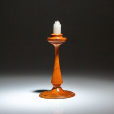 A souvenir candlestick made from longleaf pine removed from the roof of the White House during the 1927 renovation.