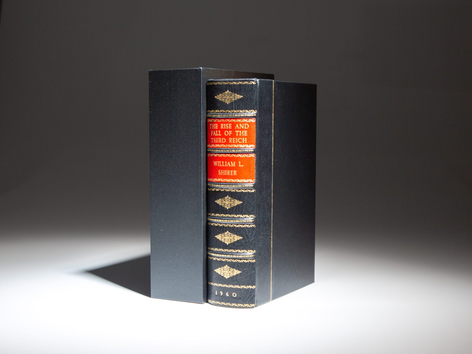 The first edition, first printing of The Rise and Fall of the Third Reich, by William L. Shirer, in a decorative morocco binding.