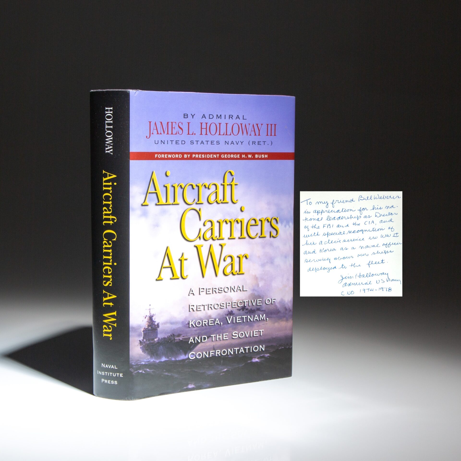 Inscribed to former FBI and CIA Director Bill Webster, the first edition of Aircraft Carriers at War by Admiral James L. Holloway III.
