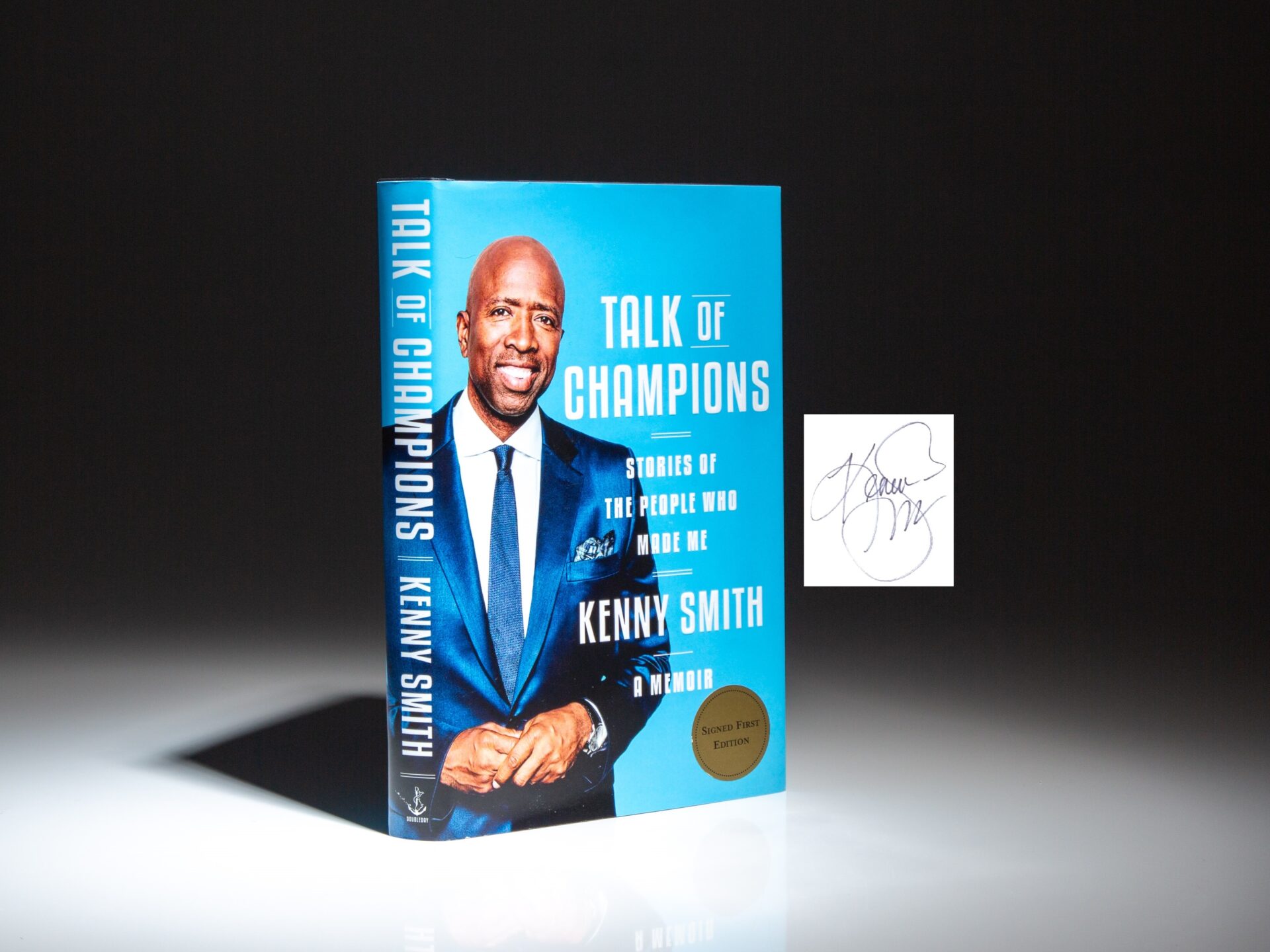 The signed first edition, first printing of Talk of Champions: Stories of the People Who Made Me: A Memoir by Kenny Smith.