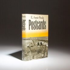 The first edition, first printing of Postcards by Edna Ann Proulx, winner of the Faulkner Award.