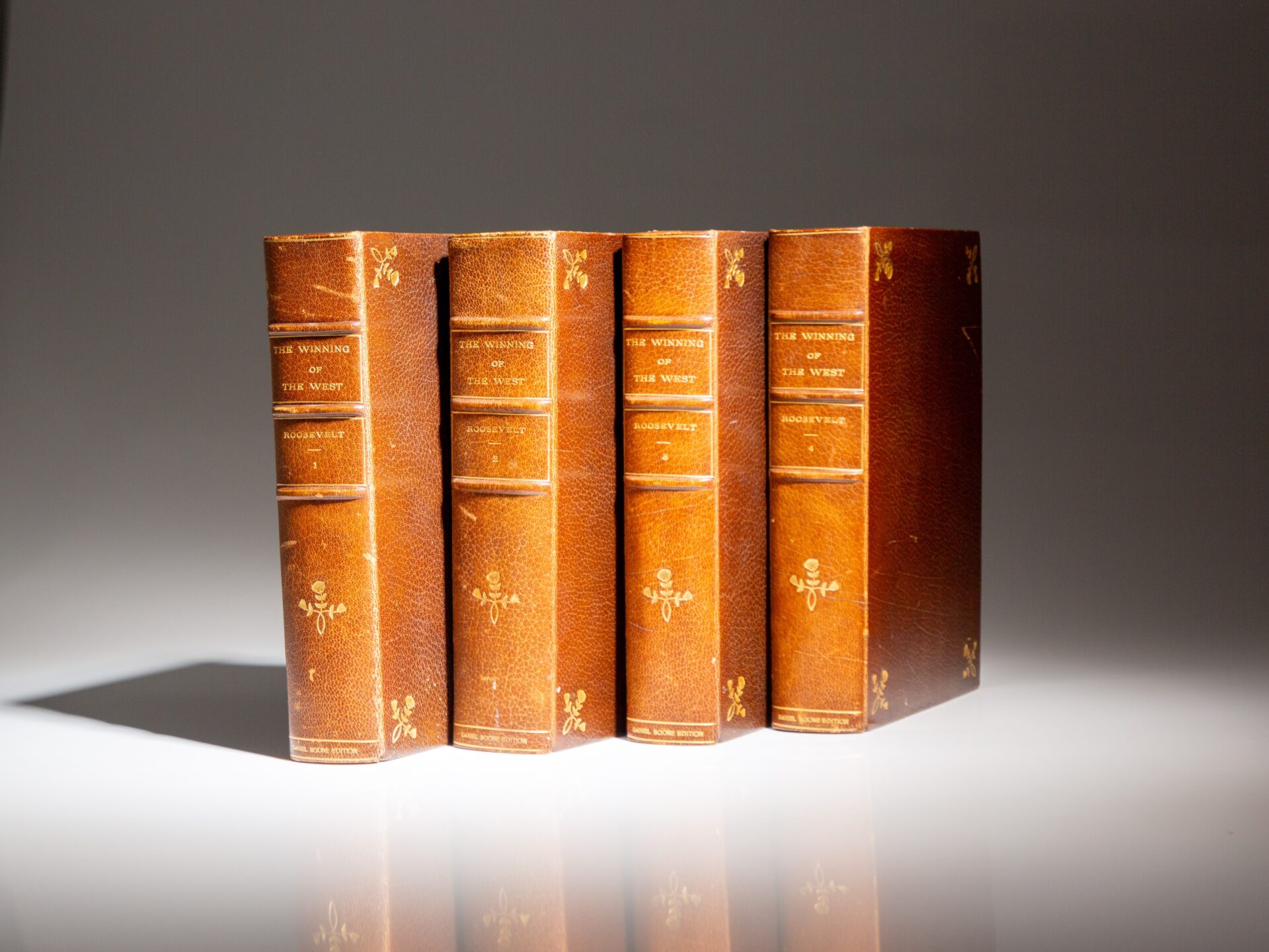 The Daniel Boone Edition of The Winning of the West by Theodore Roosevelt, with a manuscript leaf in Roosevelt's hand.